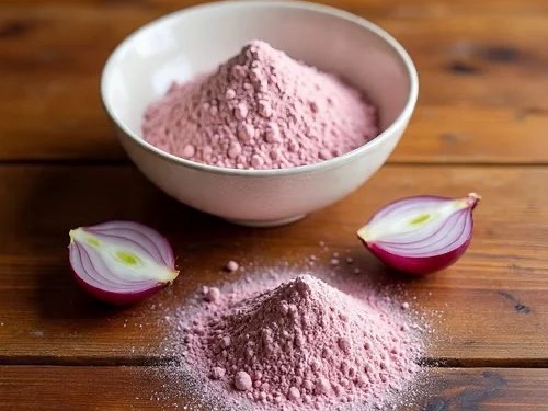 Pink onion powder in a bowl with halved red onions